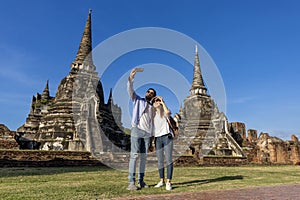 Couple of foreign tourists take selfie photo at Wat Phra Si Sanphet temple, Ayutthaya Thailand, for travel, vacation, holiday,