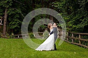 Couple in forest near wooden fence