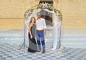 Couple formally dressed at a greek wedding