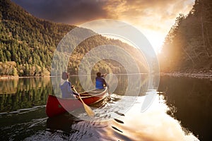 Couple friends canoeing on a wooden canoe