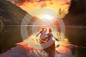 Couple friends canoeing on a wooden canoe