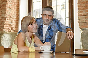 Couple or friends at coffee shop working with laptop computer in the morning happy