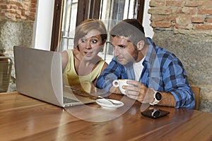 Couple or friends at coffee shop working with laptop computer in the morning happy