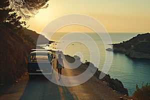 Couple of friends enjoying scenic Mediterranean view from a road side parked minivan. Travelling in camper van. Planning a road