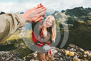 Couple friends giving five hands reached mountain top