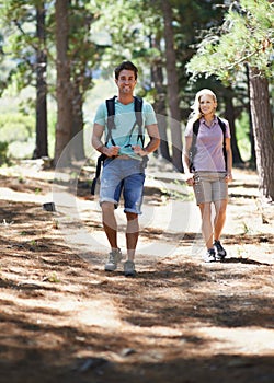 Couple of friends, travel and hiking in forest for fitness, outdoor adventure and wellness or health in nature. Portrait
