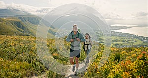 Couple of friends walking, hiking on mountain and travel for fitness, adventure or journey in nature for wellness. Young