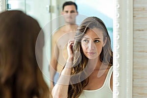 Couple in front of bathroom mirror