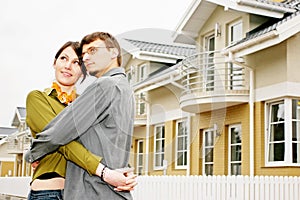 Couple in front of family house