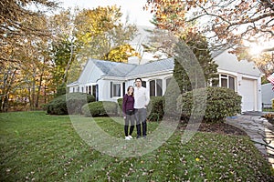 Couple standing in yard in front of house