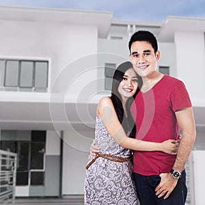 Couple In Front Of New Home