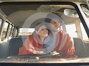 Couple In Front Seat Of Campervan