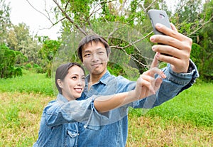 Couple fun taking self-portrait picture photos with mobile smart