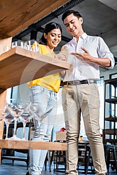 Couple in furniture store choosing glasses