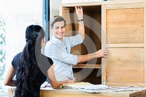 Couple in furniture store choosing material