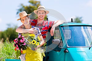 Couple in garden with flowers on gape photo