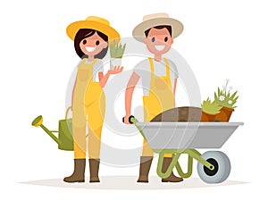 A couple of gardeners. Man with wheelbarrow of earth, a woman ho