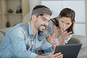 couple gesturing to person on video chat