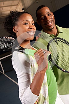 A couple gets ready to play tennis
