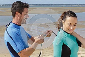 couple getting ready for doing surf