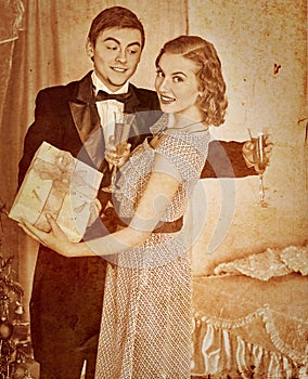 Couple with gift box. Sepia toned.