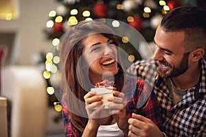 Couple with gift together on Christmas eve