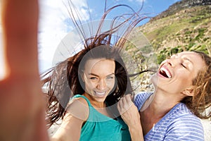 Couple of girlfriends taking fun selfies