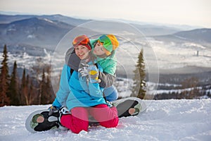 Couple of girls snowboarders are happy at the ski resort
