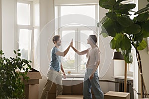 Couple giving high five congratulate each other with relocation day