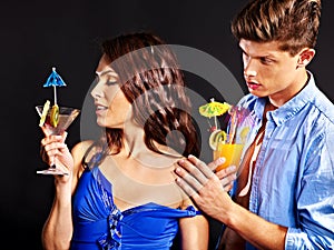 Couple with glass of cocktail.