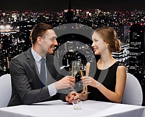 Couple with glasses of champagne at restaurant