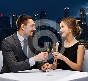 Couple with glasses of champagne at restaurant