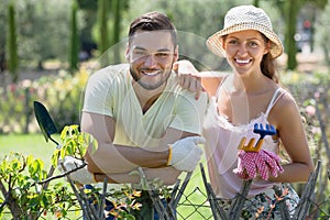 Couple in gloves with horticultural sundry