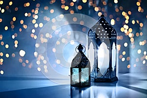 Couple of glowing Moroccan ornamental lanterns on the table. Greeting card, invitation for Muslim holy month Ramadan photo