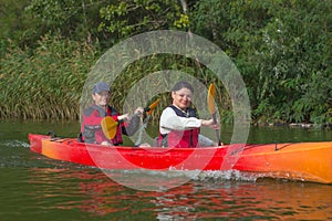 The couple goes kayaking on the river.