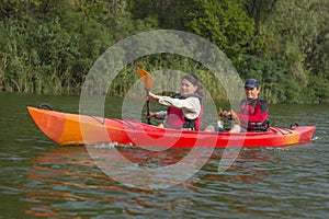 The couple goes kayaking on the river.