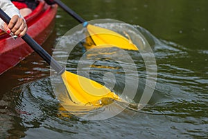 The couple goes kayaking on the river.