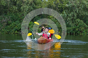 The couple goes kayaking on the river.