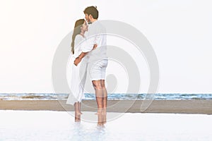 Couple going honeymoon on tropical beach in summer