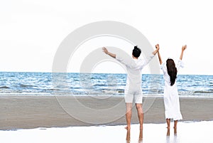 Couple going honeymoon on tropical beach in summer