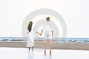 Couple going honeymoon on tropical beach in summer