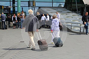 Couple travels with hand luggage from Amsterdam Schiphol airport, Netherlands