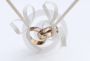 Couple of gold wedding rings with bows