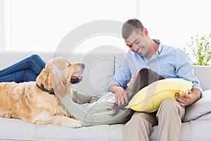 Couple with Golden Retriever on sofa