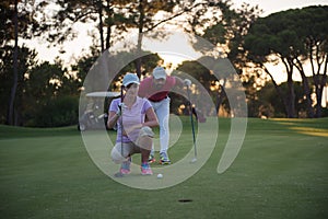 Couple on golf course at sunset