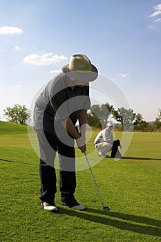 Couple of golfers on the green.