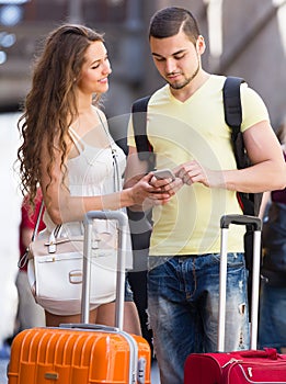 Couple with GPS navigator and baggage
