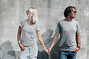 Couple in gray t-shirt over street wall