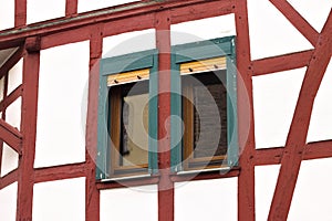 A couple of green windows of an half - timbered house Germany