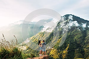 The couple greets the sunrise in the mountains